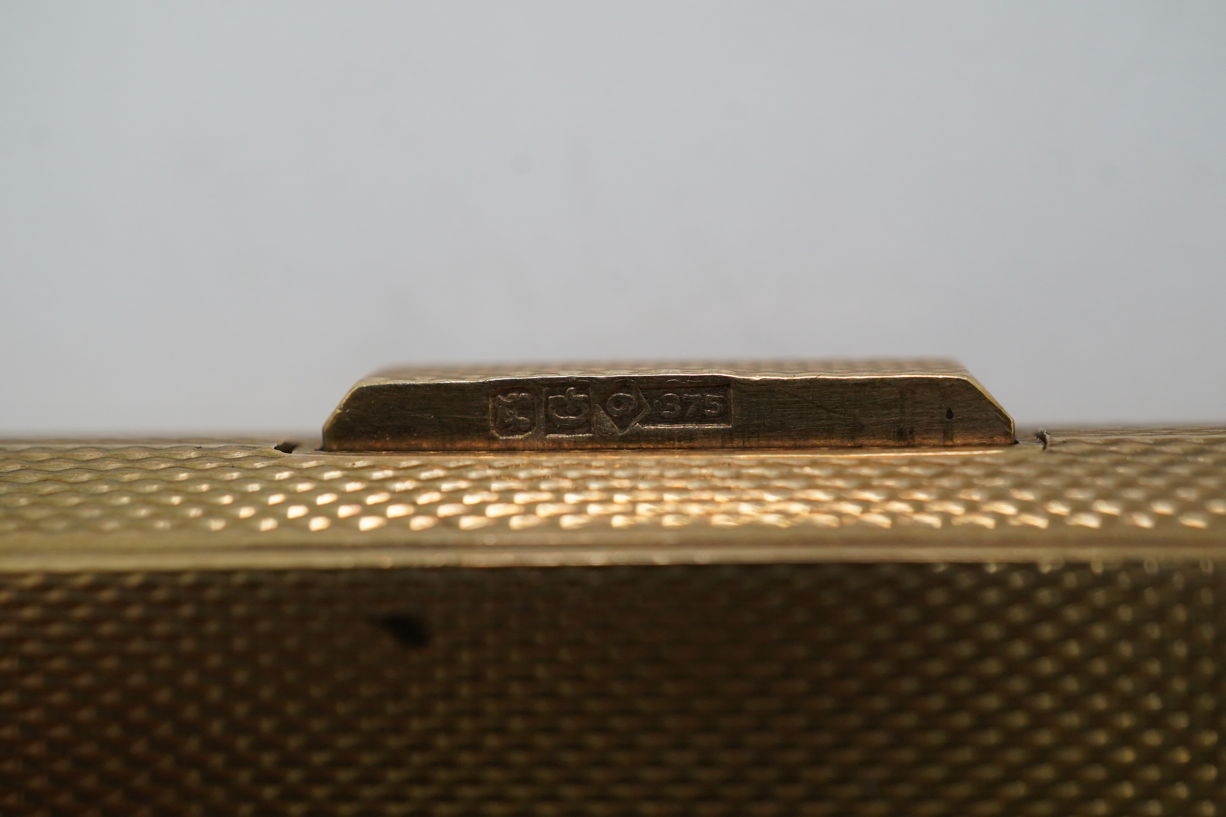 A 9ct gold rectangular cigarette case, circa 1947